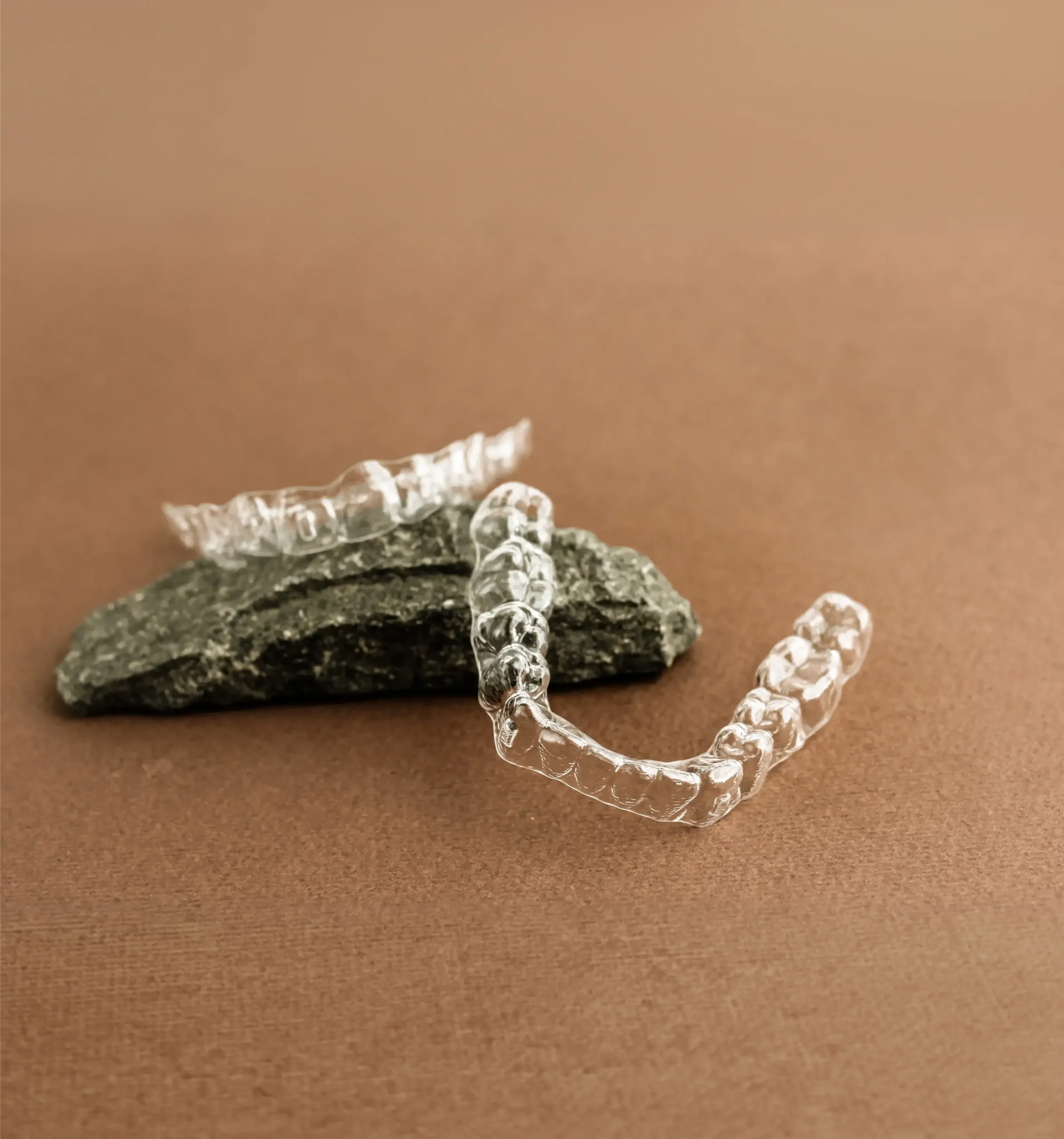 Clear aligners resting on a stone