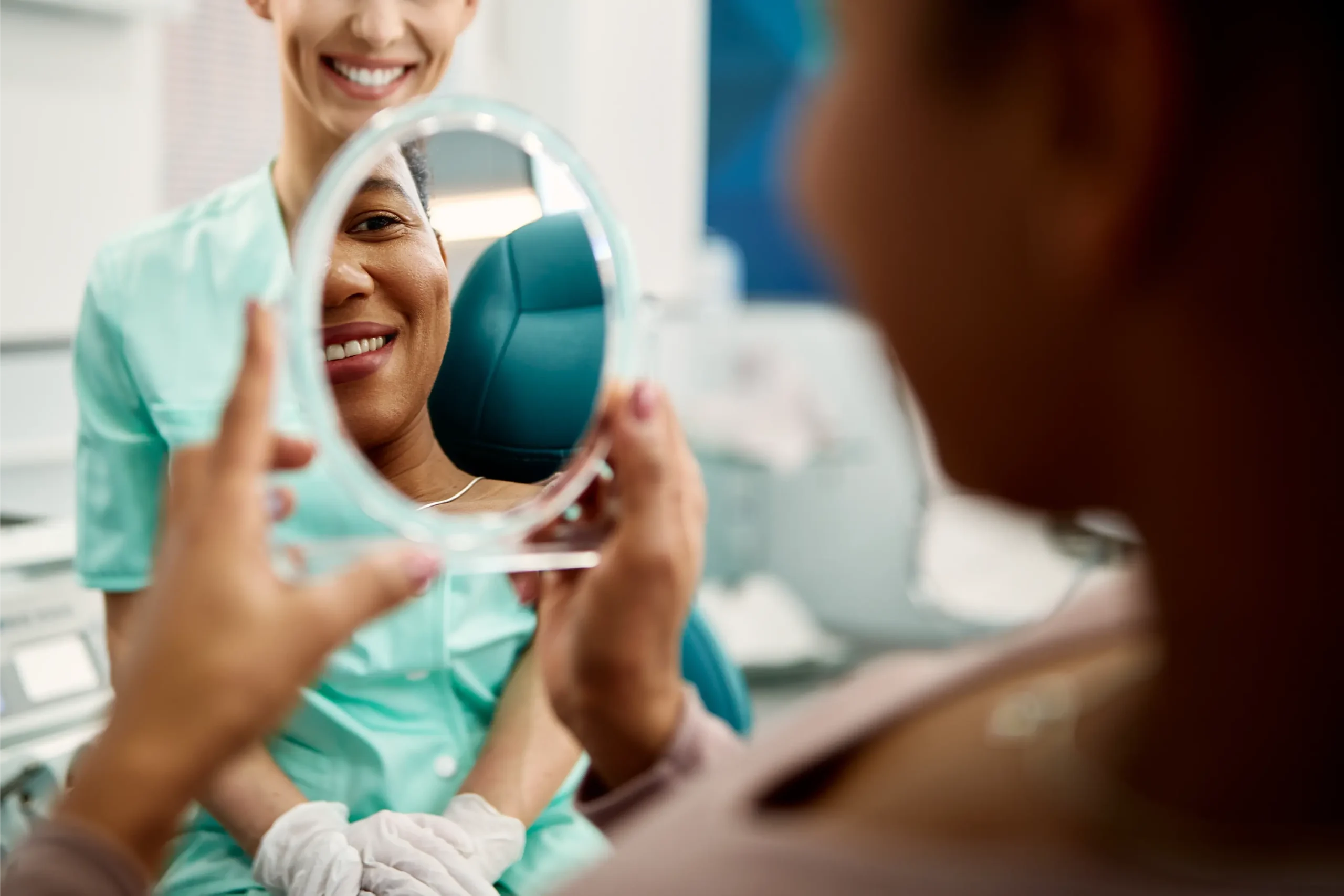 Woman checking her teeth in a mirror