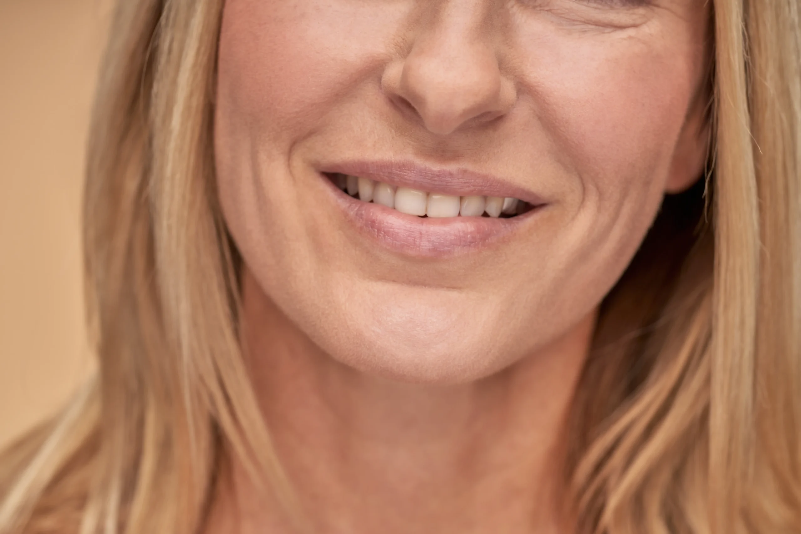 Close-up of a smiling woman with blonde hair