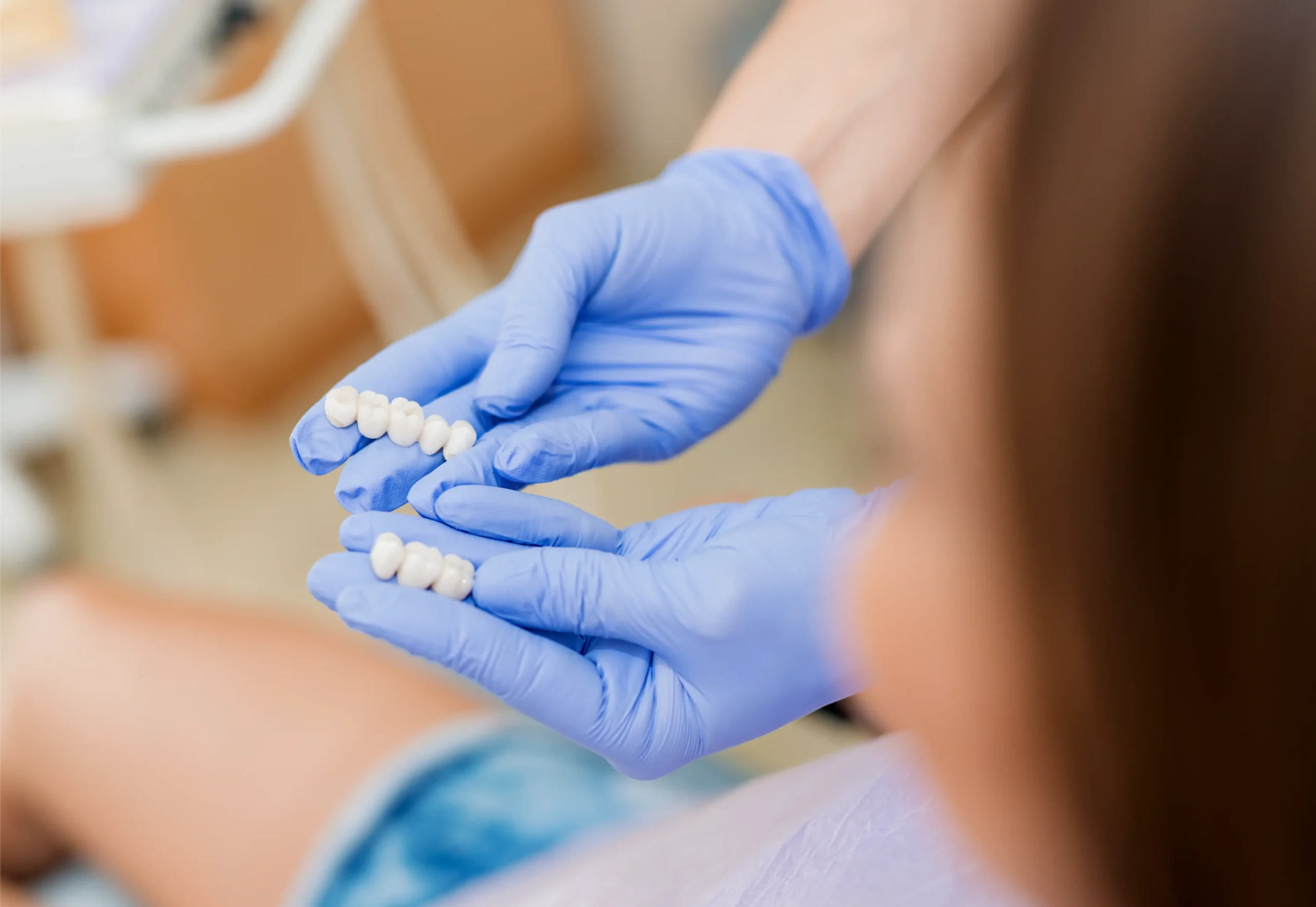 Dentist holding a dental bridge