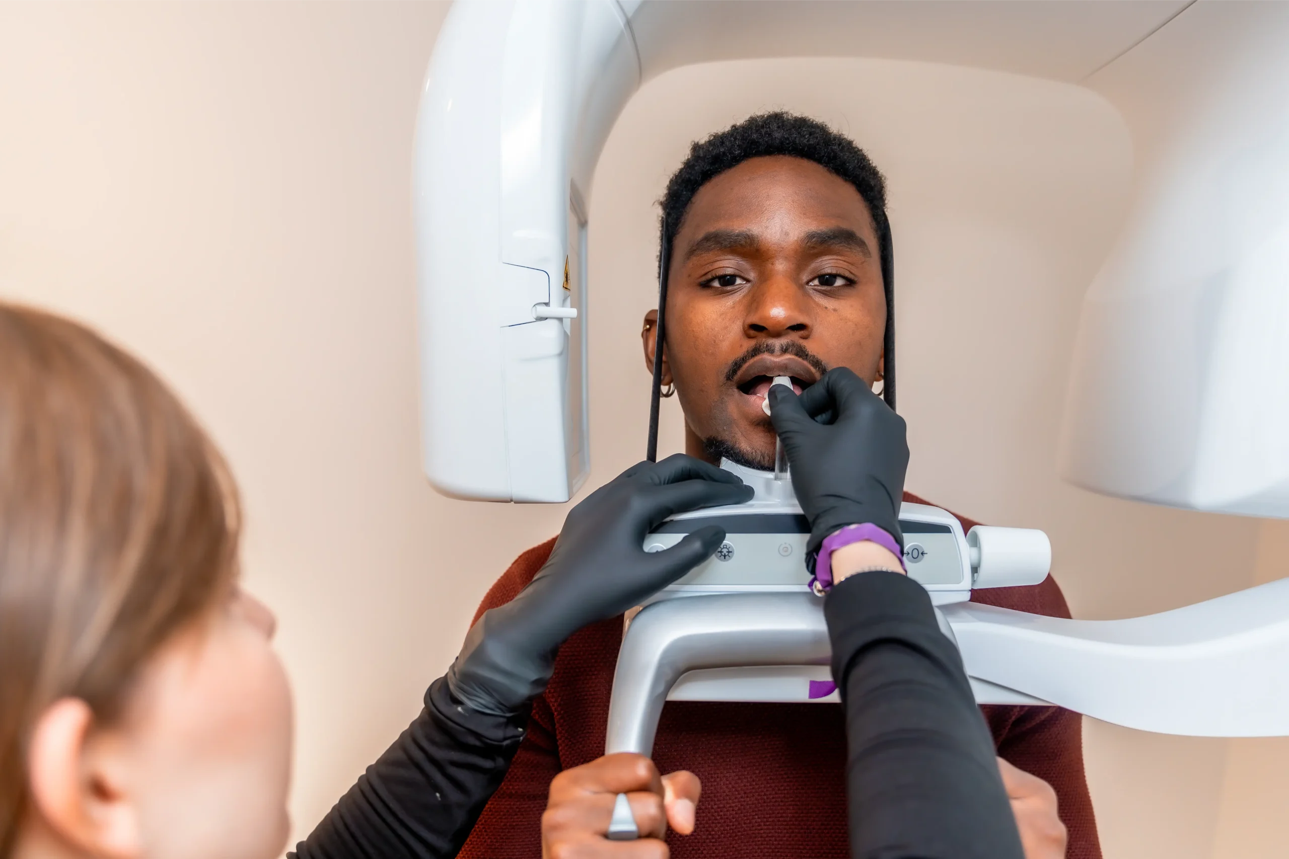 Dentist positioning a patient for a dental X-ray