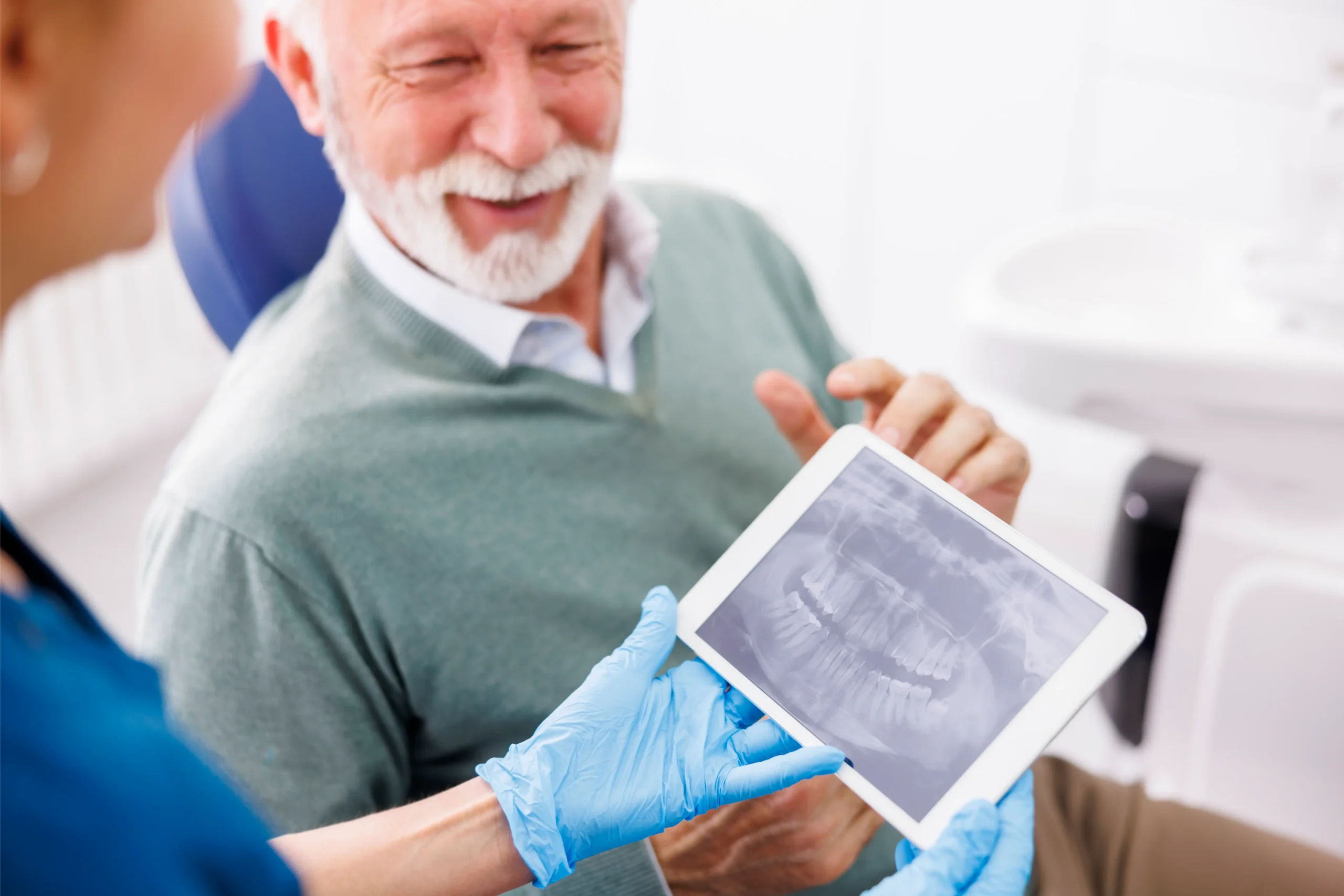 Dentist and patient looking at a jaw X-ray