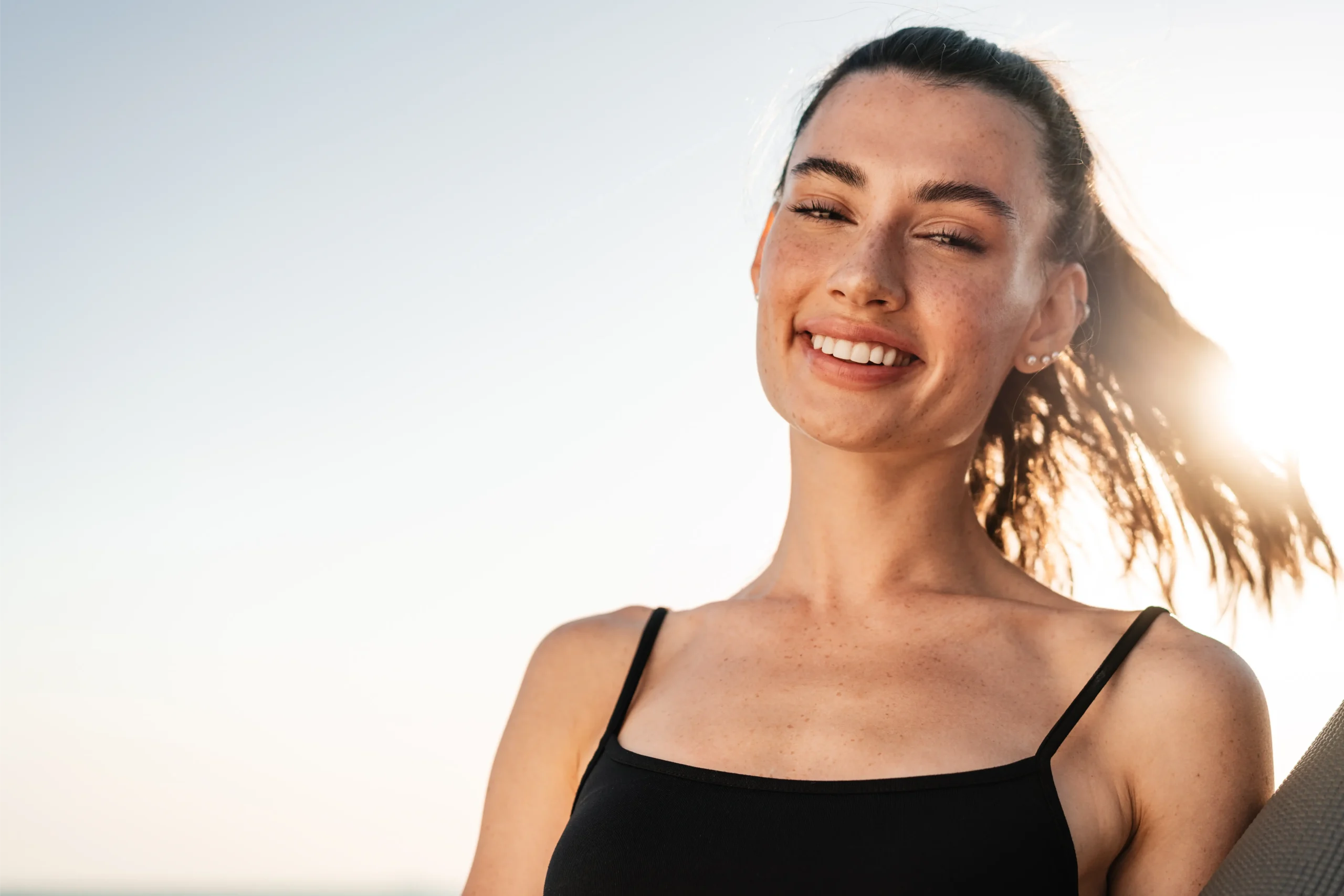 Smiling woman outdoors at the beach