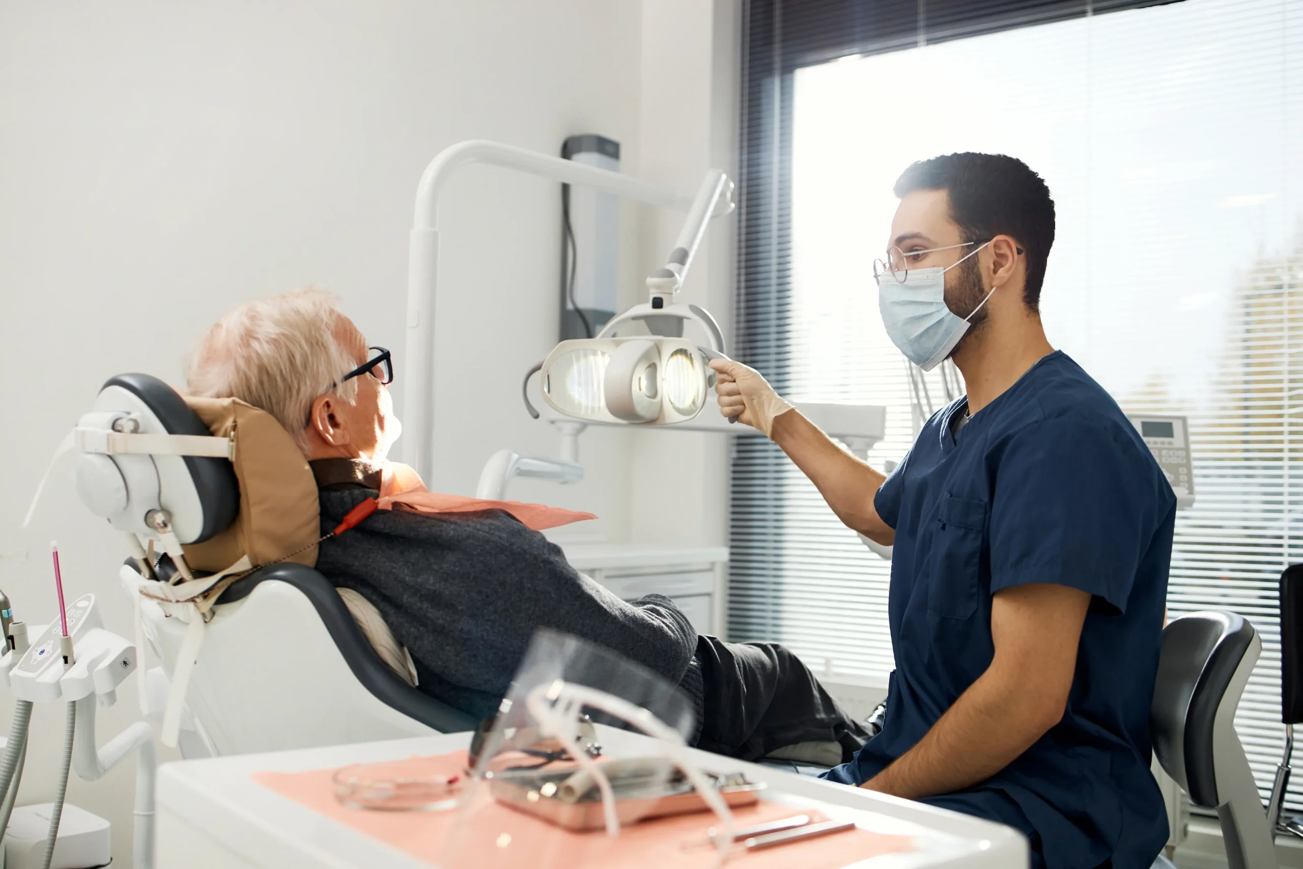 Dentist examining an older patient