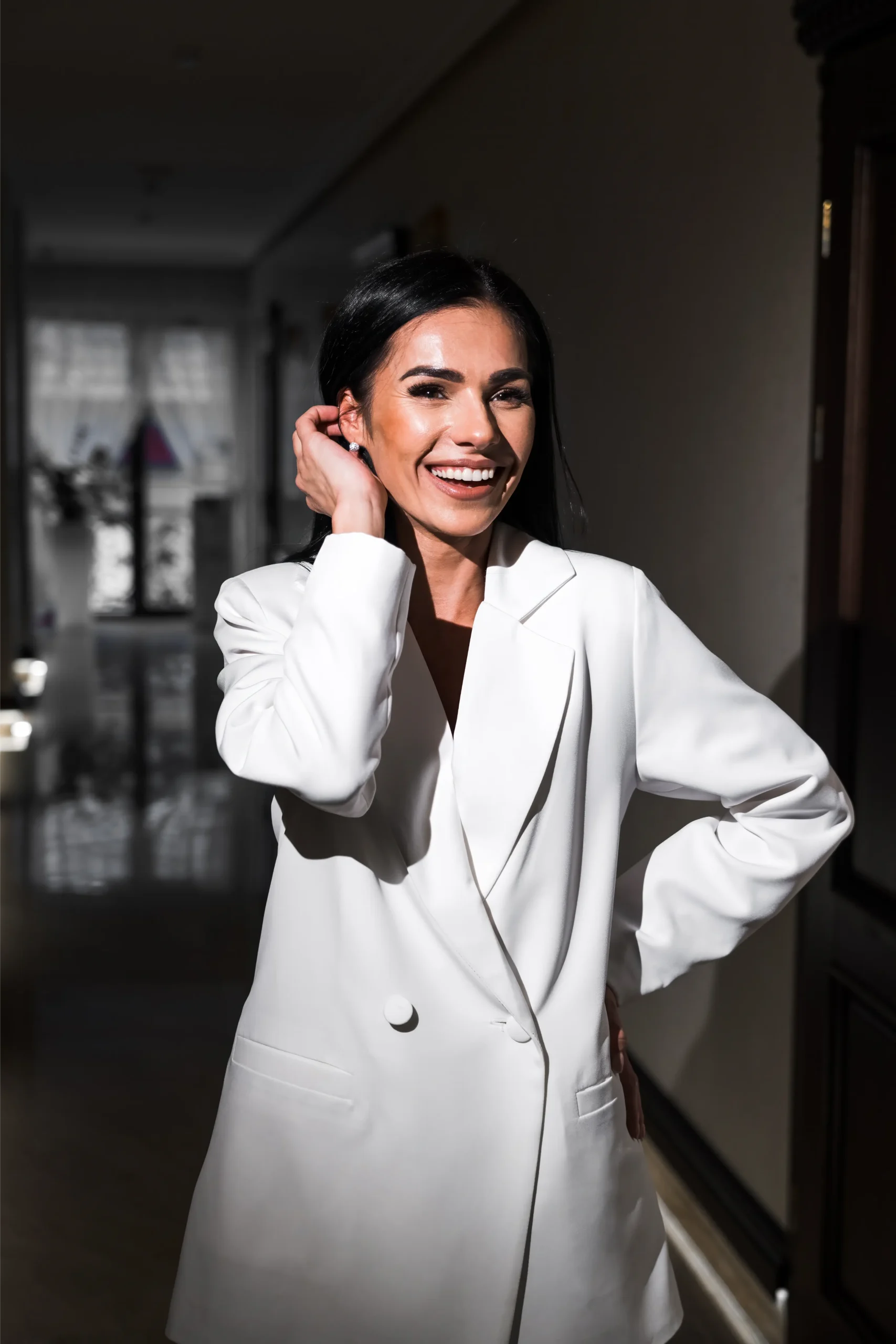 Smiling woman in a white blazer