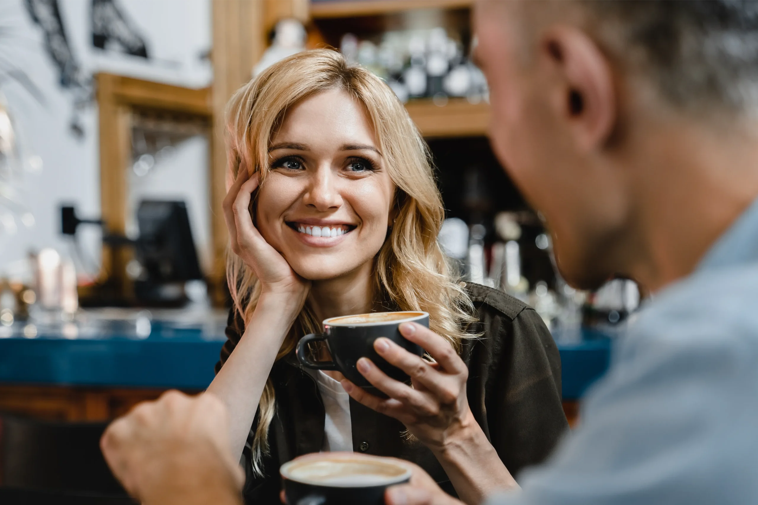 Smiling woman enjoying a coffee with a friend