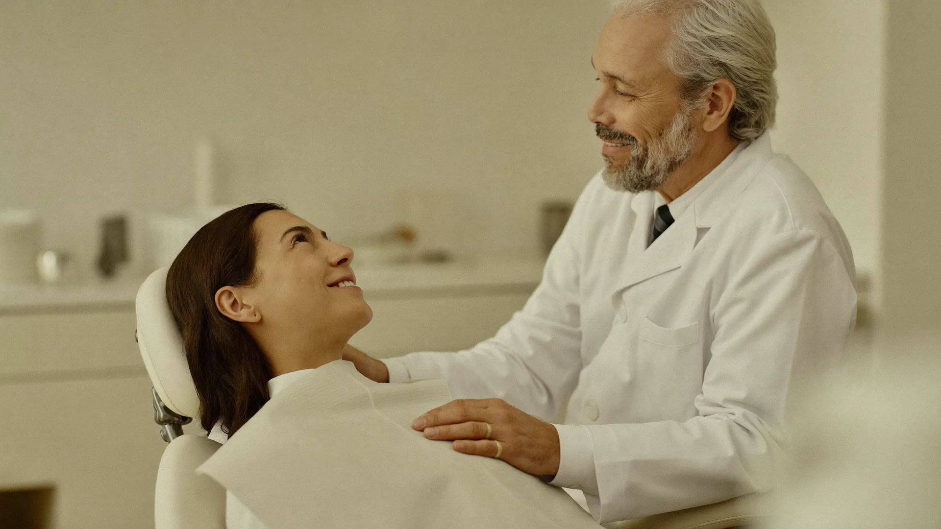 Dentist reassuring a patient in the dental chair