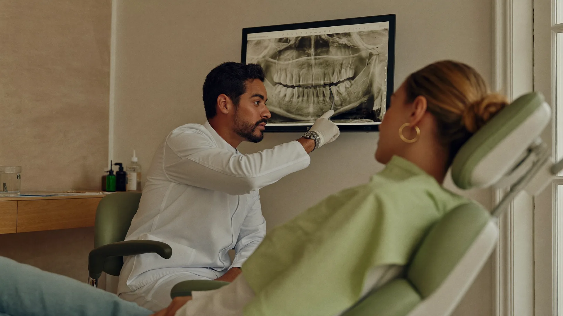 Dentist reviewing a dental X-ray with a patient in the chair