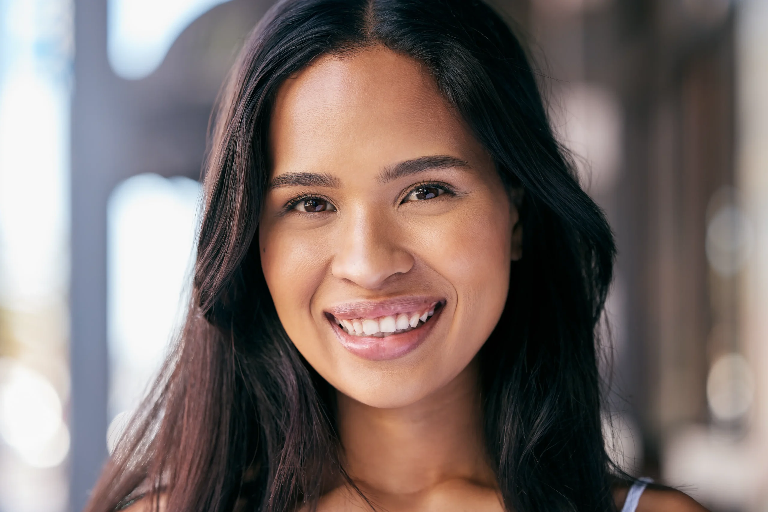 Woman with glowing skin on a summer day in the city